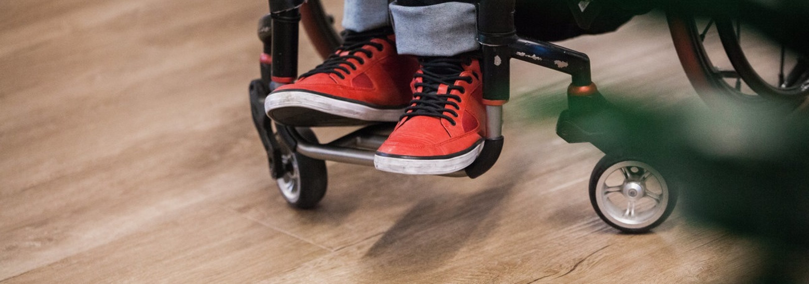 wheelchair wheels and red sneakers