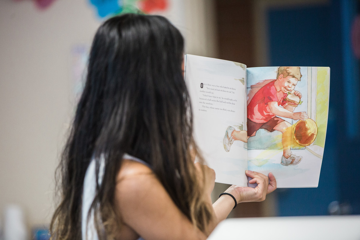 student reads picture book about rick hansen