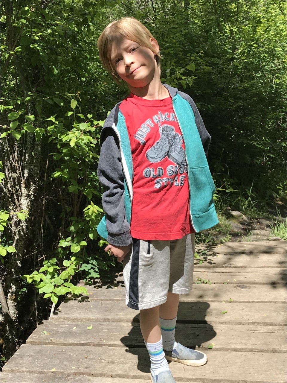 Young boy standing in a garden