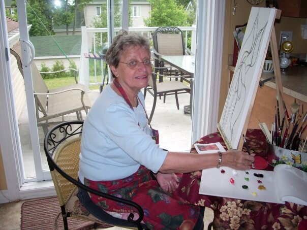 woman painting at a table