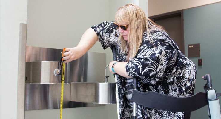 woman uses tape measure