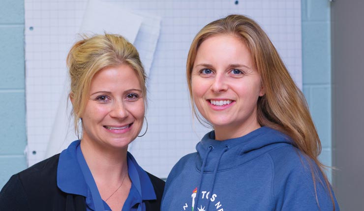 Jennifer and colleague smiles for the camera. 