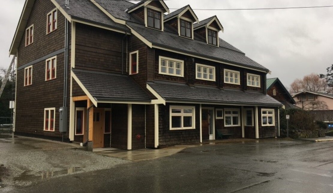 The Salt Spring and Southern Gulf Islands Community Services Society (SSICS) McPhillips Building. It is a large brown building with three peak windows on top.